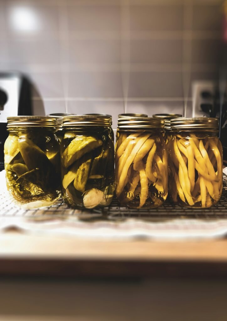 Fruits and vegetables with lemon zest stored in jar kept on the brown table